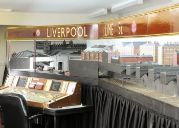 John Holden has built a giant model of Liverpool Lime Street train station. See Ross Parry story RPYTRAIN; A rail enthusiast who fell in love with a train station as a child has now recreated it in full - in his BUNGALOW. Trainspotter John Holden, 69, has built a 45ft replica of Liverpool's Lime Street Station in his house. John has fond memories of trips to Liverpool as a youngster and first had the idea for the model while still a schoolboy. But it took almost 30 years for his dream to come to fruition. John has been crafting the stunning scale model for decades and it even includes station announcements, model trains, working signals and moving taxis and buses. His space-consuming hobby fills the entire extension of the detached bungalow in the East coast seaside town of St Annes, near Blackpool., he shares with wife, Pauline. The model, which shows the station in the 1940s, even boasts a sound system providing ambient background noise, train hooters and whistles and it also includes surrounding streets and nearby buildings, along with tiny figures of railway workers and passers-by. The couple’s current home was specifically chosen because there was space to accommodate the model. John said: “It has just grown and grown.”