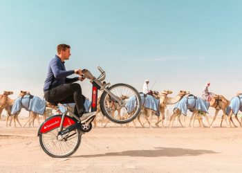 Chris Astil-Smith, 24 (L) with his The Boris bike in Dubai. See National copy NNBIKE: A biking mad entrepreneur made a round the world cycling trip - on a Boris bike. Chris Astil-Smith, 24, rented the Boris bike and cycled around seven cities including New Delhi, Las Vegas and Paris. For three weeks in January Chris cycled around five countries and spent two days in each city capturing the trip with friend and videographer Alex Tyrwhitt. He faced security trouble in New York as well as Delhi where the entrepreneur was forced to bribe security £10 at the Taj Mahal to cycle inside.