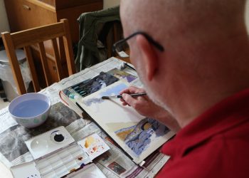 Blind artist from Fetcham, Surrey, having an exhibition at Leatherhead Theatre. John Mitchell from Fetcham, Surrey, is an exhibiting artist despite being registered blind as he has tunnel Vision. John Mitchell a talented watercolour artist has learnt to paint stunning landscapes despite being registered blind. See National story NNBLIND;  John Mitchell, 58, developed a love for landscapes and geometric shapes in his 30s but was forced to put his canvas down when he developed a mysterious illness.  He later developed complete tunnel vision and was recovering from at home on the sofa when he was inspired to brush off the dust on his paintbox. The registered blind artist, who now has no peripheral vision at all, uses a white stick to get around but can see clearly enough to see the colours in front of him. His blindness forces him to paint smaller landscapes and he is unable to draw a straight line.