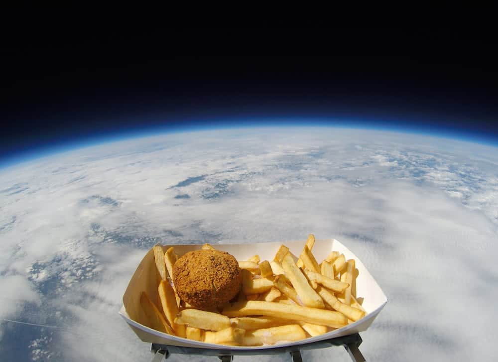 A RADIO station has joined the race for space - by blasting a beloved savoury dish into the stars. See Ross Parry story RPYPATTIE; The NASA-style space mission took off at 8.55am, as a Hull Pattie, along with a portion of chips sprinkled with chip spice, was shot almost 38,000 metres into the stratosphere tethered to a high-altitude weather balloon. The pattie was launched from a site in Sheffield, and reached a height of over 123,000ft where temperatures fell to -50c and winds hit 150mph. An on-board camera filmed the tasty expedition, providing some stellar footage and data, as the meal touched down in a field just outside Wragby at 12.18pm.