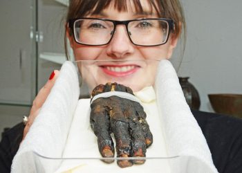 Swindon Museum collections manager Stef Vincent with their severed Egyptian hand. See SWNS story SWHAND; A severed hand wasn’t what Stef Vincent expected to find in a plastic box as she went about her job at Swindon Museum and Art Gallery. The collections project manager was sorting through objects in the cramped stores at the building in Bath Road when she made the gruesome discovery. Peeling away the lid of the box she found a withered ancient Egyptian hand, which museum staff now know belonged to a woman mummified thousands of years ago. It was a chance discovery for Stef, 35, who has worked at the Bath Road museum since 2014.