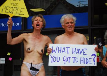 Two campaigners stage a nearly naked proest outside Shire Hall in Gloucester where plans for an incinerator have caused outrage amongst residents. See SWNS story SWPROTEST; Semi-naked activists have staged a protest outside Shire Hall in Gloucester in an attempt to reverse a decision on the controversial incinerator. The small group brandished placards outside the building yesterday afternoon in what is the latest episode in the long-running battle with the county council over the construction. As well as putting post it notes on the windows of the building, two protestors bared all for the cause, wearing nothing but pants and one had tape over her nipples. One carried a sign saying “What have you got to hide?”