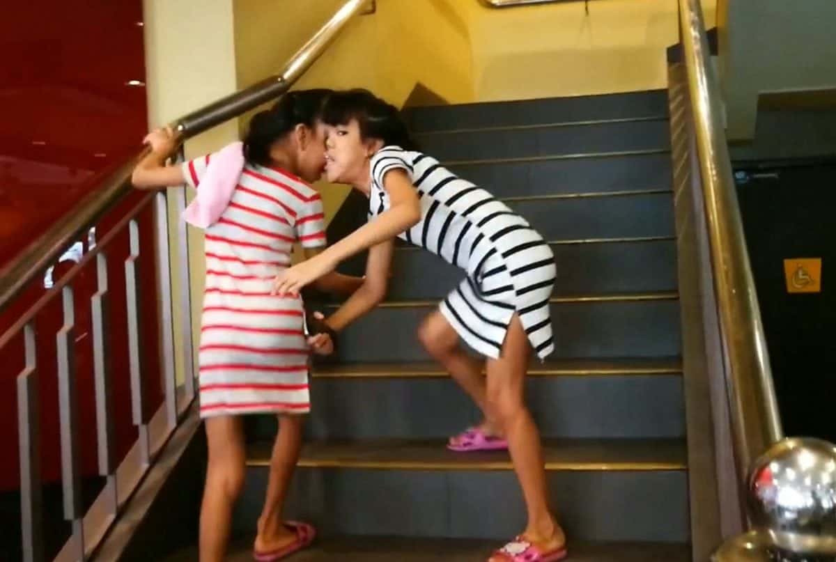The desperate family of conjoined ten-year-old twins attached at the head are appealing for help to raise £75,000 to separate them. See SWNS story SWTWINS. Joy and Joyce Magsino were born with angular frontal partial craniopagus - they are attached at the forehead. A touching video released by their father devoted Patrick Magsino, 30, shows them taking selfies and playing video games like any other ten-year-old girls. Doctors in Albay in the Philippines said it was possible to separate them with a risky and costly operation in 2012 - and the family began saving up ever since. Their father Patrick earns £6 a day as a market assistant porter, while his wife Jomarie migrated to Qatar to work as a maid to save up. But the family has only raised around a third of the cash needed - and are now appealing for help with an online fundraising page.
