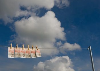 UK currency - new £50 notes - 'drying' on a washing line on a Summer's day. Symbolising money laundering.