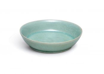 A small but highly-important ceramic dish from Imperial China is expected to sell for more than £10 MILLION at auction. See SWNS story SWBOWL; The brush washer is around 1,000 years old and was commissioned by the imperial court during the Song dynasty. And it was made by Ru guanyao, which is one of the most revered of the Five Great Kilns used during this period. The brush washer, which has a diameter of just 13cm, has a glowing, intense blue-green glaze and 'ice crackle' pattern. It is most likely the dish was made between 1086 and 1106 and it is extraordinarily rare for a Ru vessel to be sold at auction. There are thought to be just 87 pieces of Ru official ware in existence and only six have been sold publicly since 1940. The brush washer is one of only four in private hands and Sothebys will auction it in Hong Kong on October 3.