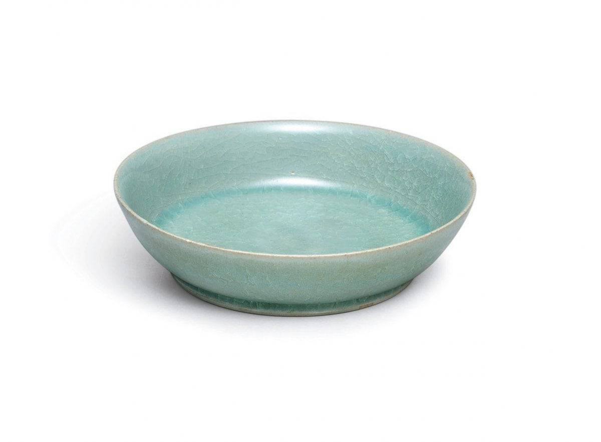 A small but highly-important ceramic dish from Imperial China is expected to sell for more than £10 MILLION at auction. See SWNS story SWBOWL; The brush washer is around 1,000 years old and was commissioned by the imperial court during the Song dynasty. And it was made by Ru guanyao, which is one of the most revered of the Five Great Kilns used during this period. The brush washer, which has a diameter of just 13cm, has a glowing, intense blue-green glaze and 'ice crackle' pattern. It is most likely the dish was made between 1086 and 1106 and it is extraordinarily rare for a Ru vessel to be sold at auction. There are thought to be just 87 pieces of Ru official ware in existence and only six have been sold publicly since 1940. The brush washer is one of only four in private hands and Sothebys will auction it in Hong Kong on October 3.