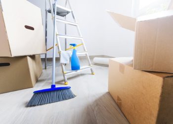 Empty room full of cardboard boxes and cleaning things for moving into a new home