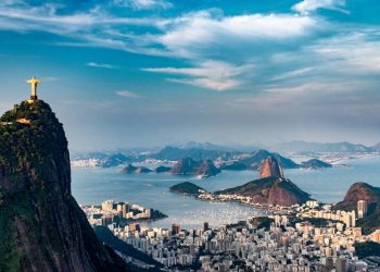 Aerial view of Rio De Janeiro. Corcovado mountain with statue of Christ the Redeemer, urban areas of Botafogo, Flamengo and Centro, Sugarloaf mountain.