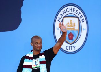 Manchester City's Vincent Kompany waves to fans during the trophy parade in Manchester.