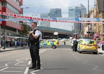 A police officer at the scene of a stabbing in Canning Town, east London (Jonathan Brady/PA)