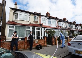 Police officers at the scene in Raymead Avenue, Thornton Heath, where Kelly Mary Fauvrelle was stabbed to death (Kirsty O’Connor/PA)
