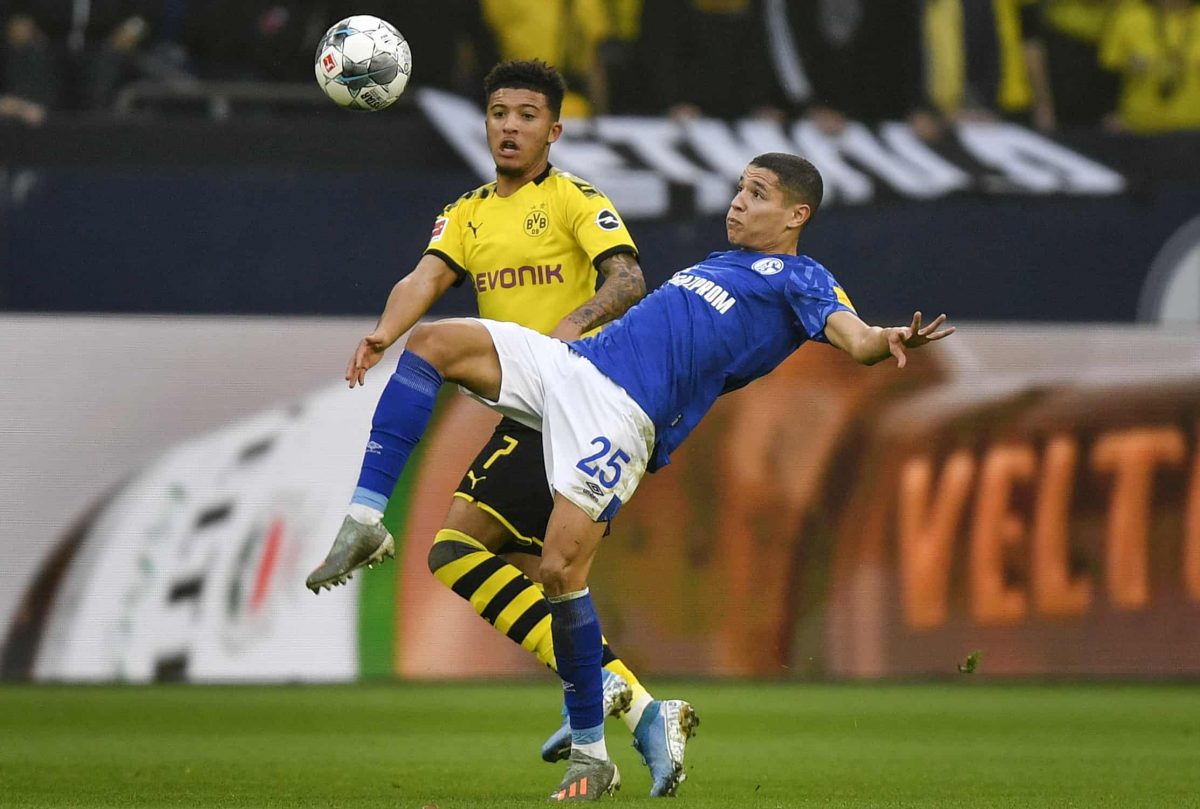 Schalke's Amine Harit, right, and Dortmund's Jadon Sancho challenge for the ball during the German Bundesliga derby soccer match between FC Schalke 04 and Borussia Dortmund in Gelsenkirchen, Germany, Saturday Oct. 26, 2019. (AP Photo/Martin Meissner)