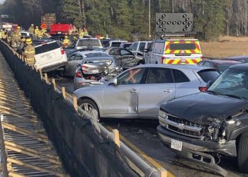 In this photo provided by the Virginia State Police, emergency personnel work the scene of a multi-vehicle pileup on Interstate 64 in York County, Va., on Sunday, Dec. 22, 2019. (Virginia State Police via AP)