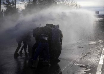 A Greek police water cannon operates from Kastanies border gate as migrants try to enter Greece from the Pazarkule border gate, Turkey at the Turkish-Greek border on Friday, March 6, 2020. Clashes erupted anew on the Greek-Turkish border Friday as migrants attempted to push through into Greece, while the European Union's foreign ministers held an emergency meeting to discuss the situation on the border and in Syria, where Turkish troops are fighting. (AP Photo)