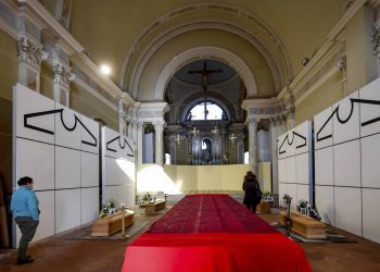 Coffins wait to be transported to cemetery, in the church of Zogno, near Bergamo, Northern Italy, Saturday, March 21, 2020. Italy’s tally of coronavirus cases and deaths keeps rising, with new day-to-day highs: 793 dead and 6,557 new cases. For most people, the new coronavirus causes only mild or moderate symptoms. For some it can cause more severe illness. (Claudio Furlan/LaPresse via AP)