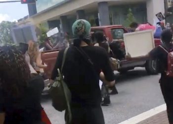 In this image taken from from video provided by @alexisnscott._, a pickup truck drives through a crowd of protesters, Saturday, May 30, 2020, in Tallahassee, Fla Tallahassee police said Saturday that the driver was in custody and that no one was seriously injured.  (@alexisnscott._ via AP)