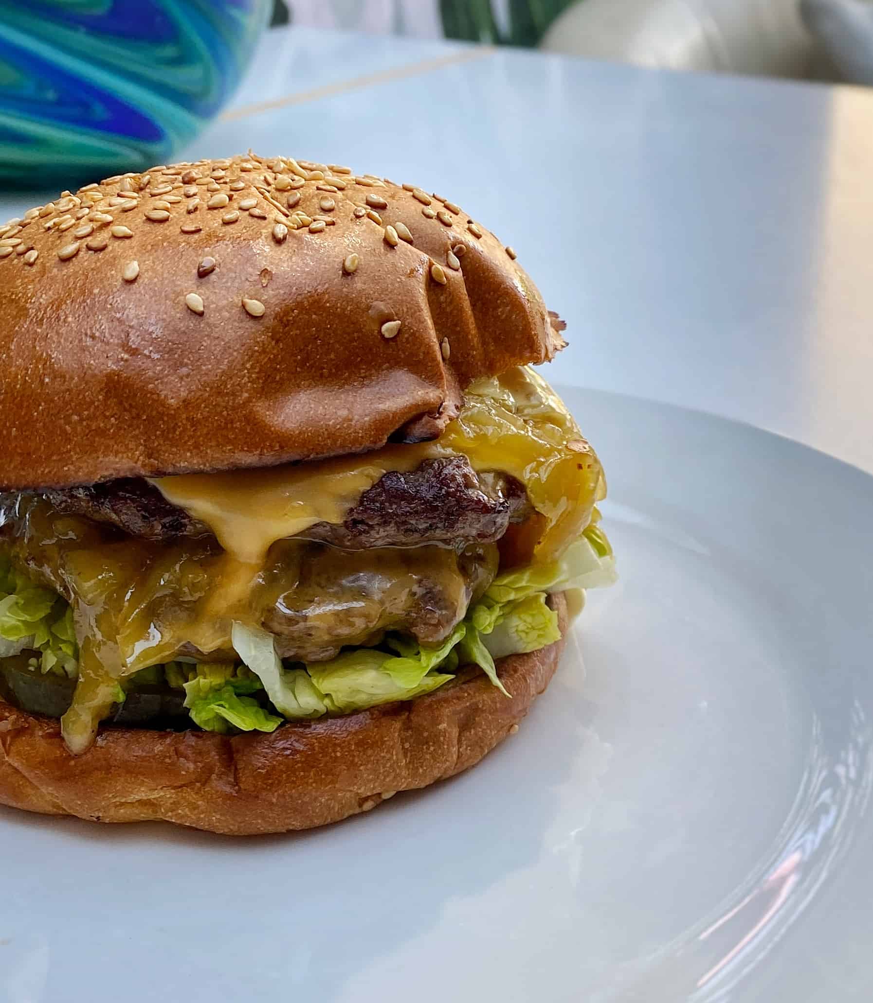 Burger recipe, with two beef patties, cheese, lettuce, onion & gherkins