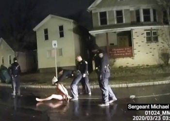In this image taken from police body camera video provided by Roth and Roth LLP, a Rochester police officer puts a hood over the head of Daniel Prude, on March 23, 2020, in Rochester, N.Y. Video of Prude, a Black man who had run naked through the streets of the western New York city, died of asphyxiation after a group of police officers put a hood over his head, then pressed his face into the pavement for two minutes, according to video and records released Wednesday, Sept. 2, 2020, by his family. Prude died March 30 after he was taken off life support, seven days after the encounter with police in Rochester. (Rochester Police via Roth and Roth LLP via AP)