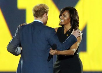Prince Harry welcomes First Lady Michelle Obama onto the stage during the opening ceremony of the Invictus Games 2016 held at ESPN Wide World of Sports in Orlando, Florida.
