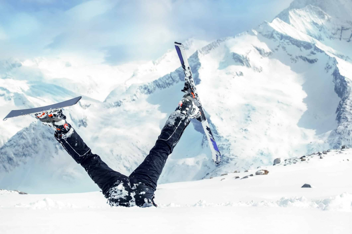 Newbie skier stuck in deep snow with his legs upside down
