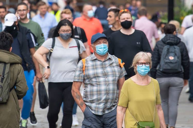 People wearing face masks among crowds of pedestrians in Covent Garden, London. Rumours were abound in the Sunday newspapers that Prime Minister Boris Johnson, who is due to update the nation this week on plans for unlocking, is due to scrap social distancing and mask-wearing requirements on so-called "Freedom Day". Picture date: Sunday July 4, 2021.