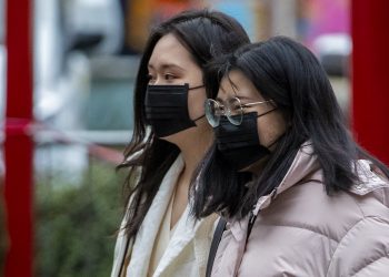 Members of the Chinese community in Manchester wearing face masks. The Government's Cobra committee is meeting in Downing Street to discuss the threat to the UK from coronavirus.