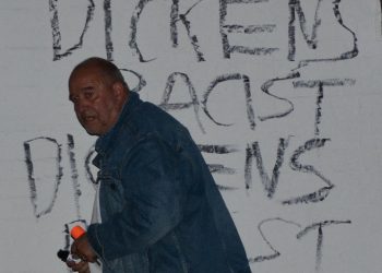Ian Driver with the graffiti he wrote.Credit;SWNS