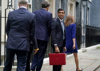 Chancellor of the Exchequer Rishi Sunak holds his ministerial 'Red Box' as he stands with his ministerial team and Parliamentary Private Secretaries, outside 11 Downing Street, London, before delivering his Budget to the House of Commons. Picture date: Wednesday October 27, 2021.