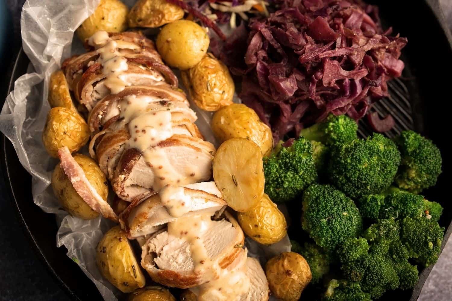 Bacon-Wrapped Pork Fillet OR Chicken served with a creamy mustard sauce and sides