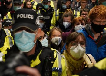 Climate activist Greta Thunberg is guidedn by police officers as she arrives at Glasgow Central train station ahead of the Cop26 summit which is taking place from Monday. Picture date: Saturday October 30, 2021.