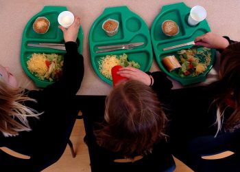 PARENTAL PERMISSION OBTAINED. Generic picture of pupils enjoying school dinners at a Primary School in Cambridgeshire.