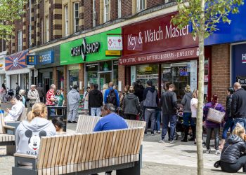 The queue outside the retail financial services provider Cash Shop in Rotherham town cente, Yorkshire. Credit:SWNS