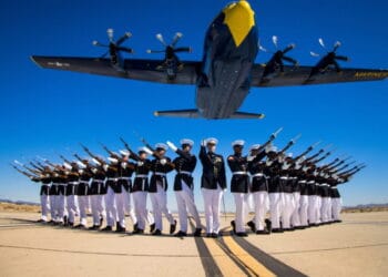 Marines of the Silent Drill Platoon, Marine Barracks Washington, execute their drill sequence during the Blue Angels’ “Fat Albert” C-130J Super Hercules fly-over at Marine Corps Air Station, Yuma, Ariz. Photo by LCpl Ramakrishna / US Marines