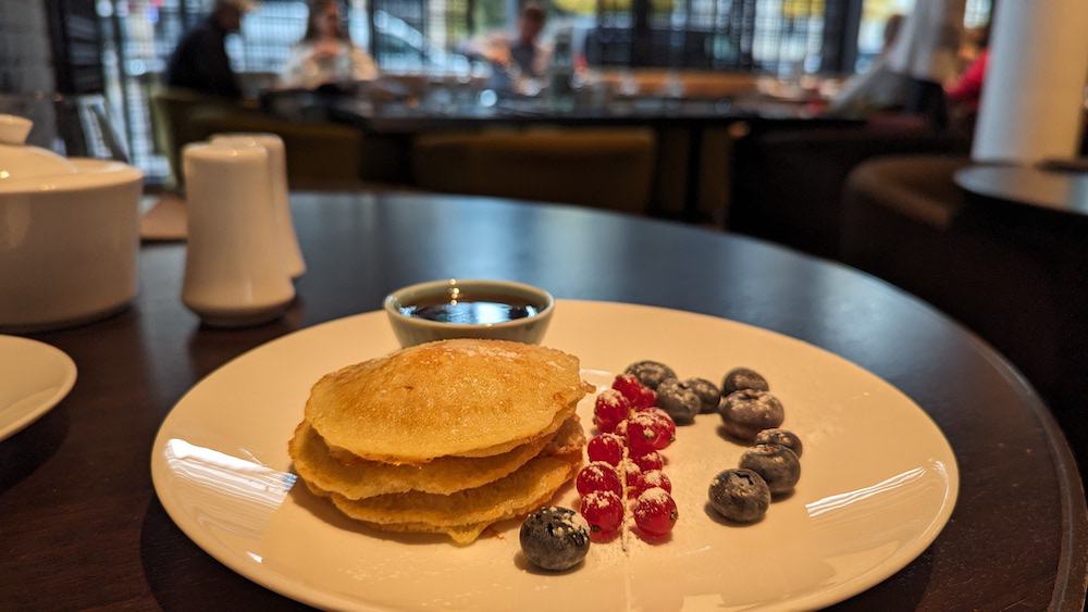 Breakfast at Roomers, Baden-Baden Breakfast of pancakes and berries, lightly dusted with icing sugar