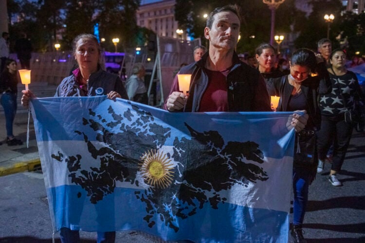 BUENOS AIRES, ARGENTINA - APRIL 02: A Malvinas war veteran and a woman hold an Argentinian flag with the Malvinas Islans drawed on April 2, 2022 in Buenos Aires, Argentina. Argentina commemorates the Argentine soldiers fallen during the Guerra de las Malvinas/Falklands Islands War on the 40th anniversary since the start of conflict against Great Britain over the sovereignty of the islands. (Photo by Ricardo Ceppi/Getty Images)