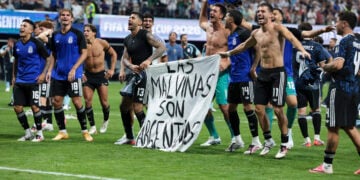 The Argentina players celebrate at full time with a banner that reads "The Falkland Islands are Argentinian" after the FIFA World Cup 2026 Semi Final match between England and Argentina at Atlanta Stadium (Getty Images)