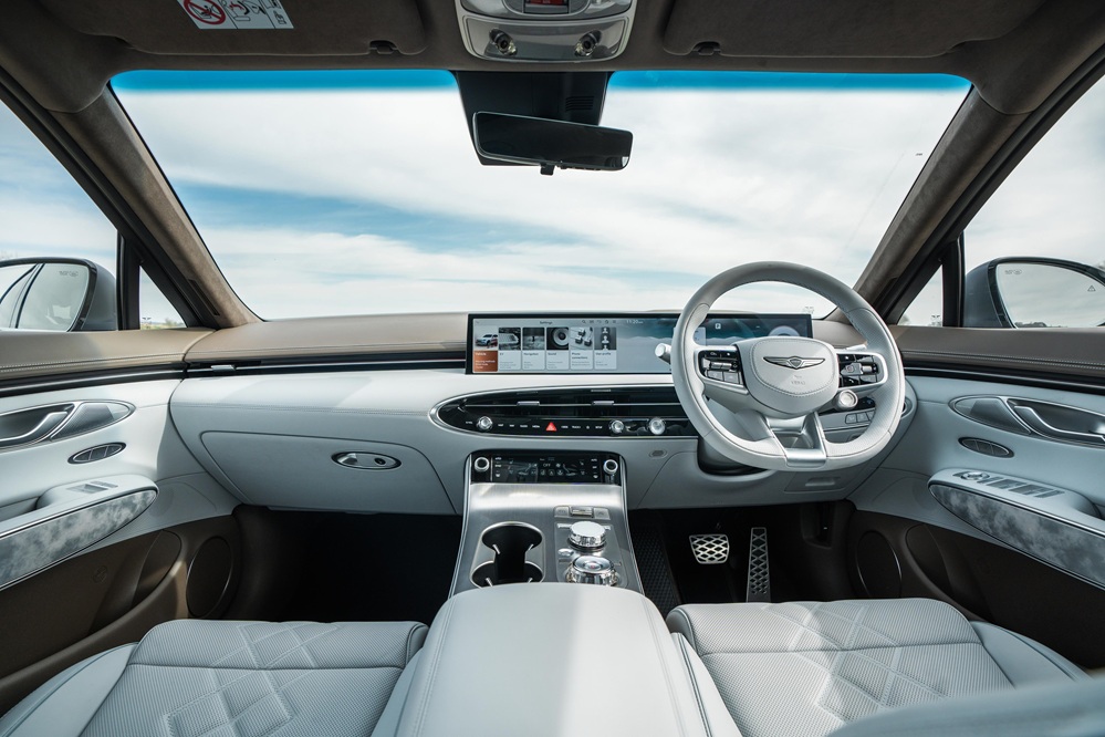 Interior shot of a right-hand drive Genesis Electrified GV70 with white interior